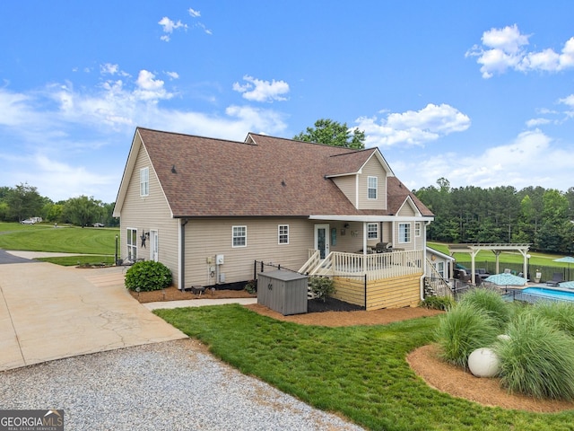 8958 Bill Savage Rd, Lula, GA 30554 - back of property featuring a wooden deck, roof with shingles, a pergola, a yard, and an outdoor pool