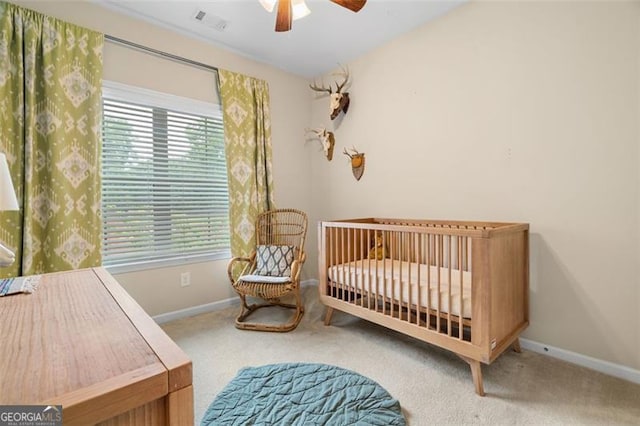 1184 Medlin St SE, Smyrna, GA 30080 - carpeted bedroom featuring baseboards, ceiling fan, and a nursery area