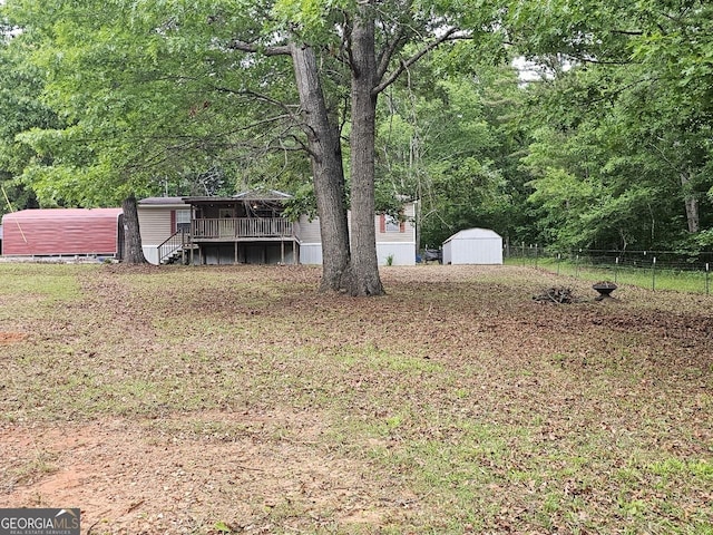 136 Hickory Hl, Anniston, AL 36206 - view of yard with a deck, stairs, and a forest view