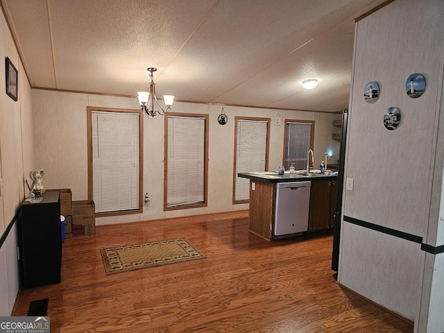 136 Hickory Hl, Anniston, AL 36206 - kitchen featuring dishwashing machine, wood finished floors, a textured ceiling, a chandelier, and a sink