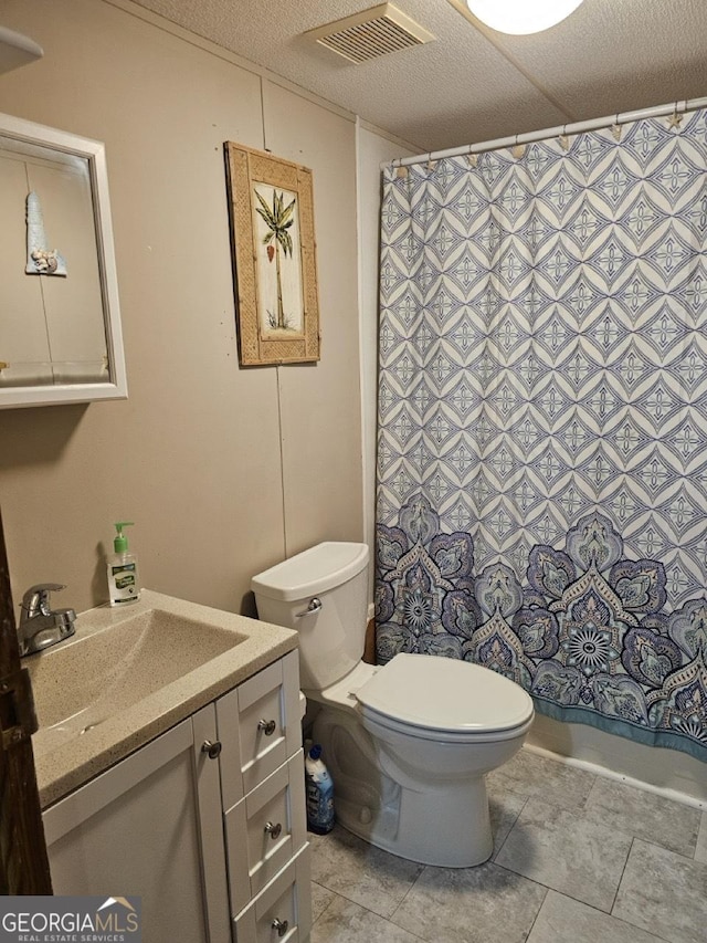 136 Hickory Hl, Anniston, AL 36206 - full bathroom featuring vanity, toilet, a shower with shower curtain, and tile patterned floors