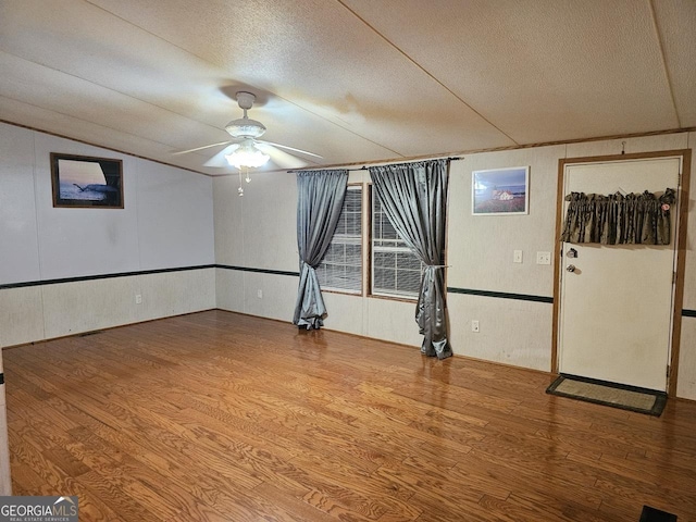 136 Hickory Hl, Anniston, AL 36206 - spare room featuring ceiling fan, wood finished floors, a textured ceiling, and vaulted ceiling