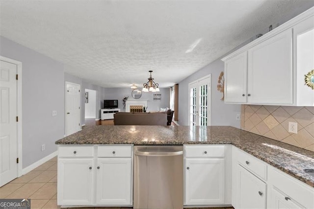 1625 Clark Lake Dr NW, Acworth, GA 30102 - kitchen with dishwasher, a peninsula, a chandelier, open floor plan, and white cabinetry