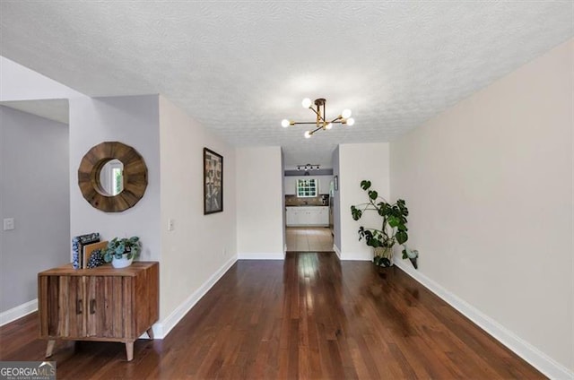 1625 Clark Lake Dr NW, Acworth, GA 30102 - hall featuring a chandelier, wood finished floors, baseboards, and a textured ceiling