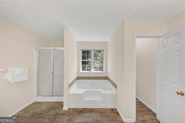 1625 Clark Lake Dr NW, Acworth, GA 30102 - full bath featuring a garden tub, a stall shower, and baseboards
