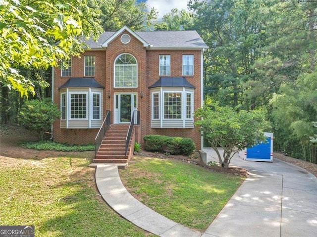 1625 Clark Lake Dr NW, Acworth, GA 30102 - view of front of property with brick siding, a front yard, concrete driveway, and stairway
