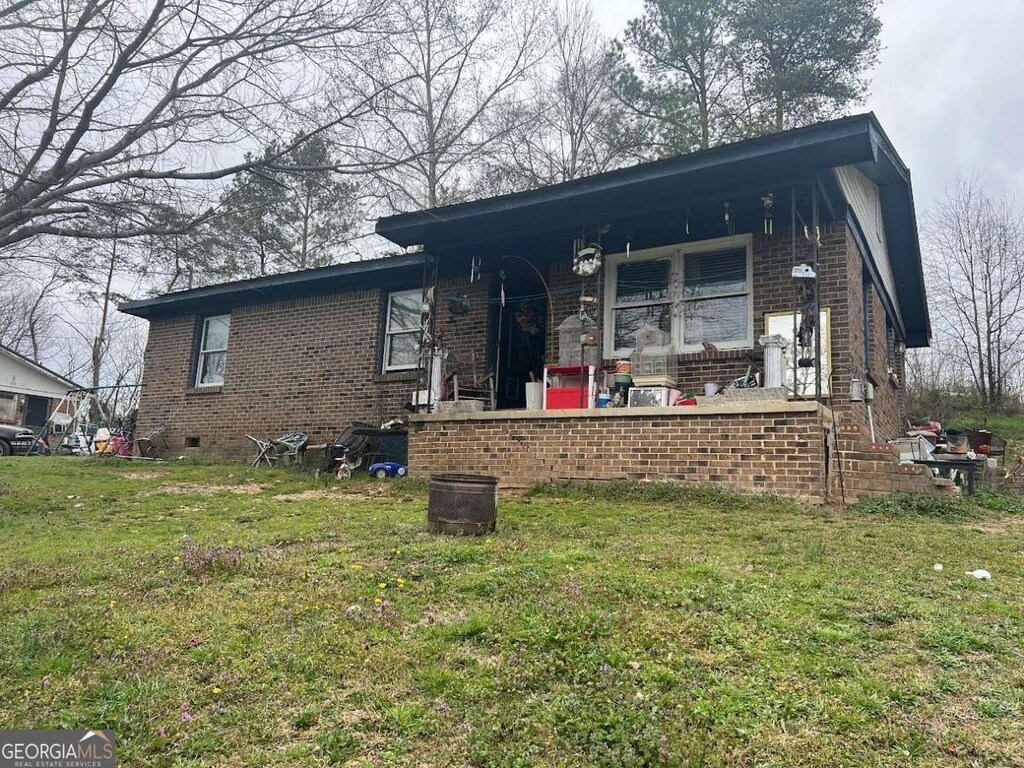 1018 Scott Brown Rd SE, Fairmount, GA 30139 - view of front of house with brick siding, a porch, and a front lawn