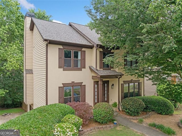 404 Pine Grove Way, Woodstock, GA 30189 - traditional-style house featuring a chimney, a shingled roof, and stucco siding