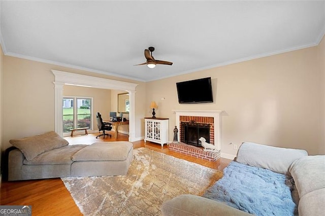 404 Pine Grove Way, Woodstock, GA 30189 - living area featuring ornamental molding, wood finished floors, ceiling fan, a fireplace, and baseboards