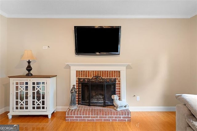 404 Pine Grove Way, Woodstock, GA 30189 - detailed view of wood finished floors, crown molding, baseboards, and a brick fireplace