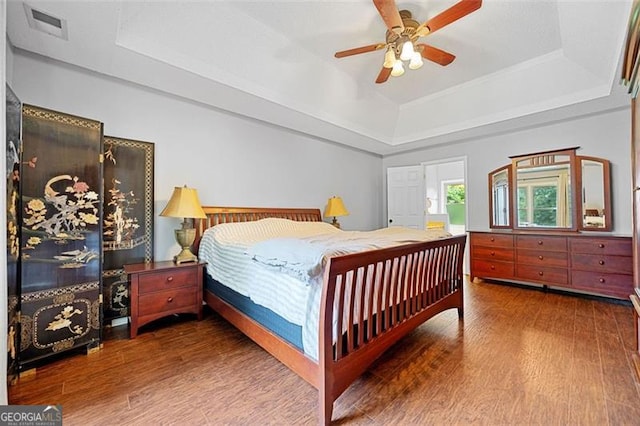 404 Pine Grove Way, Woodstock, GA 30189 - bedroom with a raised ceiling, wood finished floors, and a ceiling fan