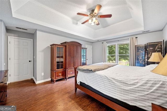 404 Pine Grove Way, Woodstock, GA 30189 - bedroom with a raised ceiling, wood finished floors, baseboards, and a ceiling fan