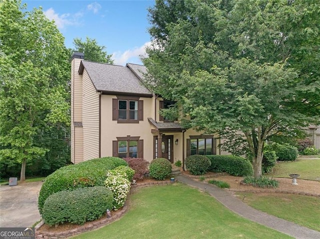 404 Pine Grove Way, Woodstock, GA 30189 - view of front facade featuring a chimney, a front yard, and stucco siding
