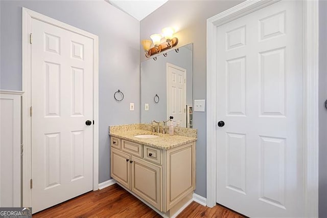 404 Pine Grove Way, Woodstock, GA 30189 - bathroom with vanity, wood finished floors, and baseboards