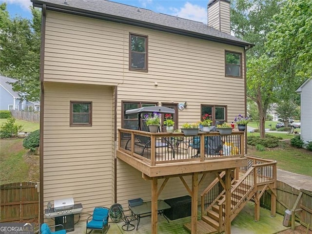 404 Pine Grove Way, Woodstock, GA 30189 - rear view of house featuring a deck, a chimney, a shingled roof, and a patio