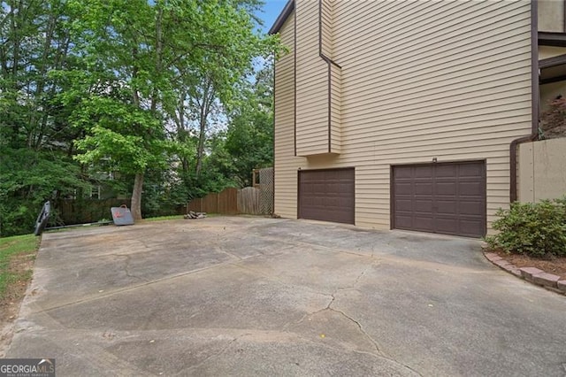 404 Pine Grove Way, Woodstock, GA 30189 - view of side of home featuring an attached garage and concrete driveway