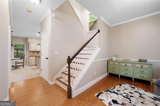 404 Pine Grove Way, Woodstock, GA 30189 - staircase featuring wood finished floors, crown molding, baseboards, and a textured ceiling