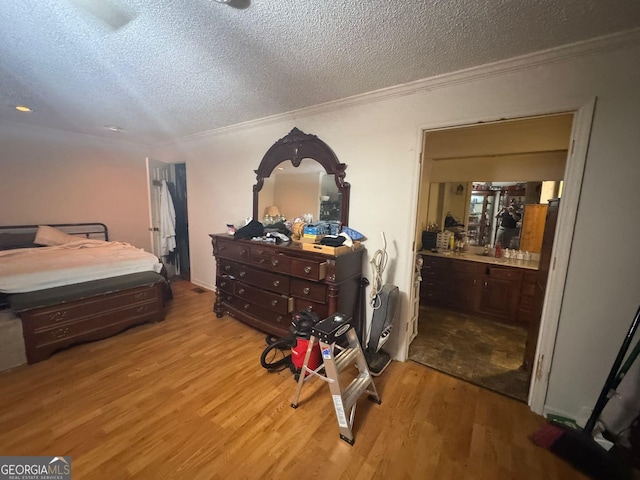 114 Van Dr, Kathleen, GA 31047 - bedroom with a textured ceiling, wood finished floors, crown molding, and connected bathroom