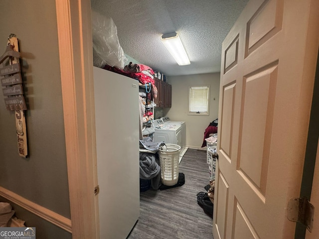 114 Van Dr, Kathleen, GA 31047 - laundry area featuring cabinet space, washer and clothes dryer, a textured ceiling, dark wood finished floors, and baseboards