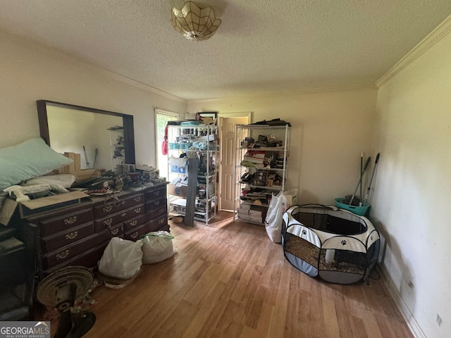 114 Van Dr, Kathleen, GA 31047 - bedroom featuring a textured ceiling, ornamental molding, and wood finished floors