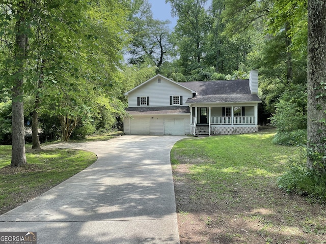 3840 Whitaker Ln, Lithia Springs, GA 30122 - tri-level home featuring covered porch, a garage, driveway, a chimney, and a front yard