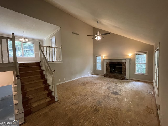 3840 Whitaker Ln, Lithia Springs, GA 30122 - unfurnished living room with vaulted ceiling, plenty of natural light, a ceiling fan, and a chandelier