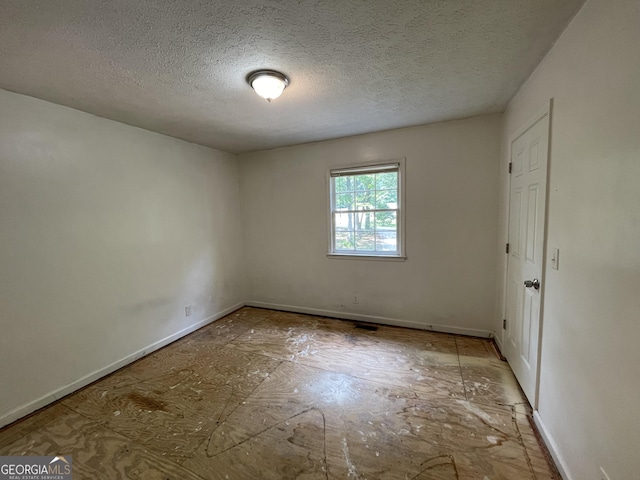 3840 Whitaker Ln, Lithia Springs, GA 30122 - unfurnished bedroom with baseboards and a textured ceiling