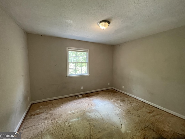 3840 Whitaker Ln, Lithia Springs, GA 30122 - unfurnished room with baseboards and a textured ceiling