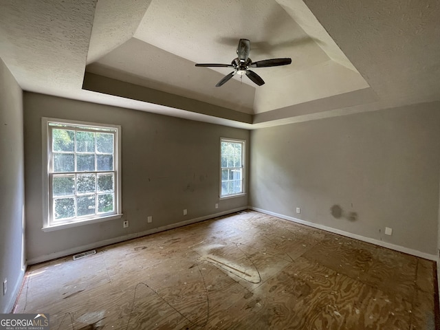 3840 Whitaker Ln, Lithia Springs, GA 30122 - unfurnished room with a tray ceiling, ceiling fan, a textured ceiling, and baseboards