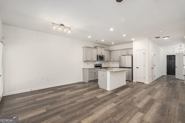 3473 Shoal Oak Ct, Riverdale, GA 30296 - kitchen with appliances with stainless steel finishes, gray cabinetry, recessed lighting, dark wood-style floors, and a kitchen island with sink