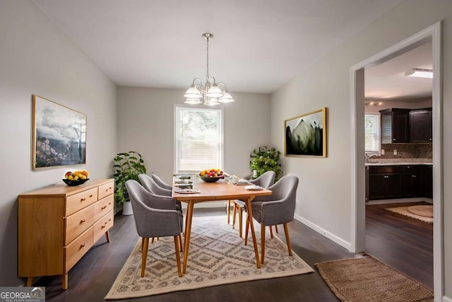 4331 Wrexham Ct, Snellville, GA 30039 - dining space with a chandelier, dark wood-style floors, and baseboards