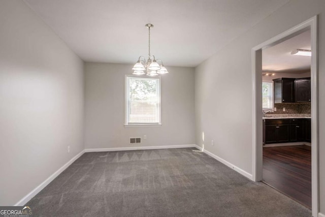 4331 Wrexham Ct, Snellville, GA 30039 - unfurnished room with dark colored carpet, a chandelier, and baseboards