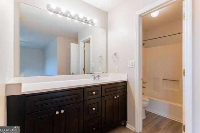 4331 Wrexham Ct, Snellville, GA 30039 - bathroom with toilet, wood finished floors, vanity, and shower / washtub combination