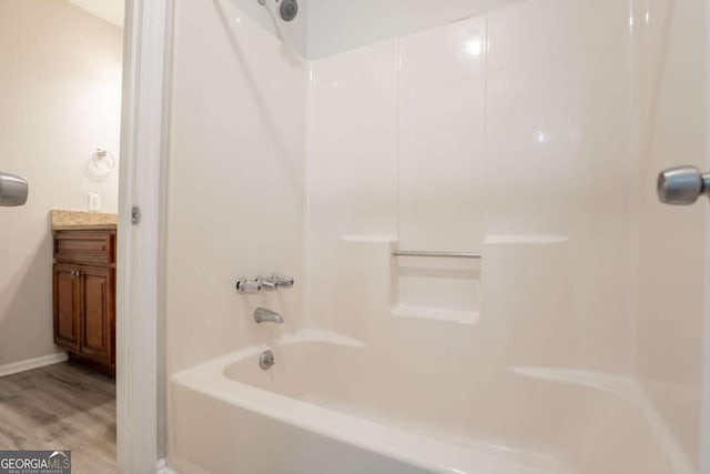 4331 Wrexham Ct, Snellville, GA 30039 - full bath featuring bathing tub / shower combination, wood finished floors, vanity, and baseboards