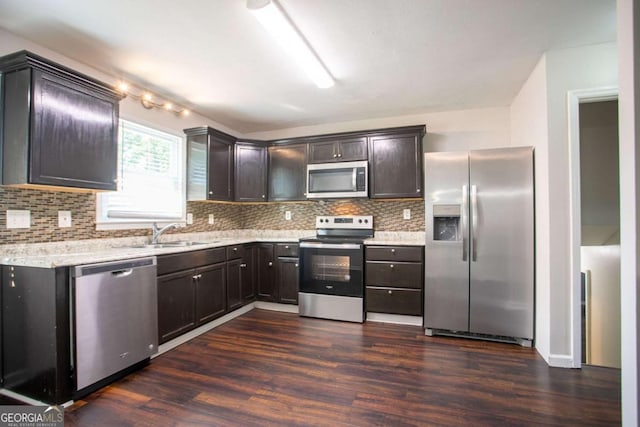 4331 Wrexham Ct, Snellville, GA 30039 - kitchen with stainless steel appliances, dark wood-style flooring, backsplash, and dark brown cabinets