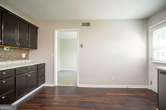 4331 Wrexham Ct, Snellville, GA 30039 - kitchen with dark wood-type flooring, stainless steel dishwasher, backsplash, light countertops, and dark brown cabinetry