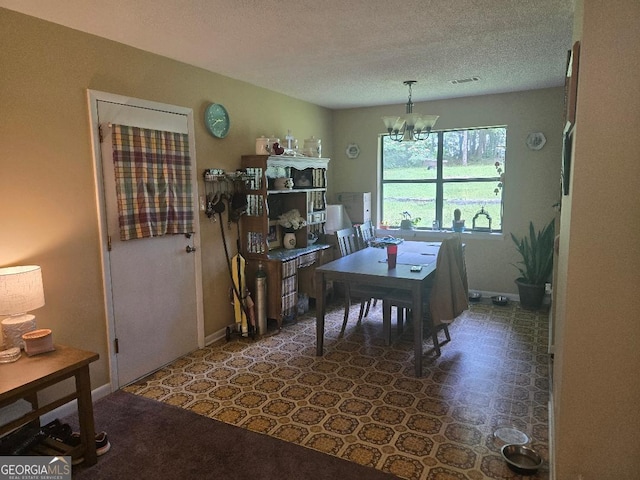 1453 Rose Ln, Toccoa, GA 30577 - dining space with a textured ceiling, a chandelier, a desk, and baseboards