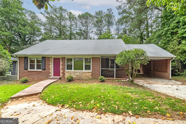 3080 Lynhurst Cir SW, Atlanta, GA 30311 - ranch-style house with driveway, a carport, and a front lawn