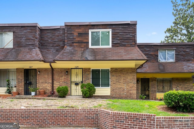 169 Peyton Pl SW, Atlanta, GA 30311 - view of front of property featuring mansard roof, brick siding, and roof with shingles
