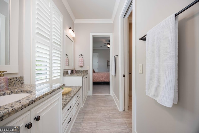 8218 Lallarook Dr, Columbus, GA 31909 - ensuite bathroom with ornamental molding, two vanities, marble look tiles, a ceiling fan, and baseboards