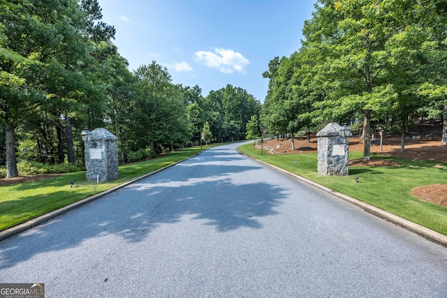 8218 Lallarook Dr, Columbus, GA 31909 - view of asphalt road with street lights and curbs