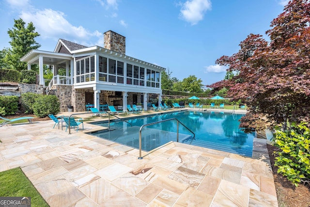 8218 Lallarook Dr, Columbus, GA 31909 - community pool with a patio area and a sunroom