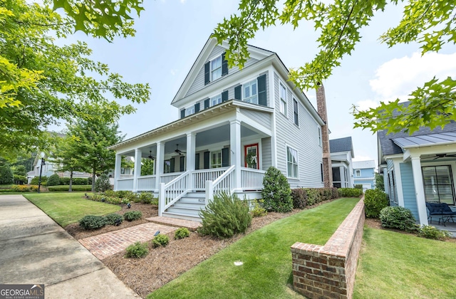 8218 Lallarook Dr, Columbus, GA 31909 - view of front of house featuring ceiling fan, a porch, a front yard, and a chimney
