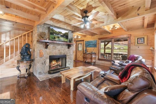 281 Wildwood Ct, Dawsonville, GA 30534 - living room featuring wooden ceiling with exposed beams, wooden walls, a stone fireplace, hardwood / wood-style floors, and ceiling fan
