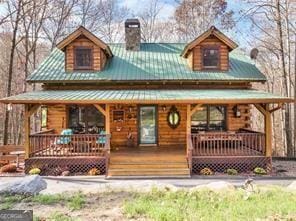 281 Wildwood Ct, Dawsonville, GA 30534 - view of front of property with covered porch, a chimney, and metal roof