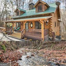 281 Wildwood Ct, Dawsonville, GA 30534 - cabin featuring a porch, a chimney, and log siding