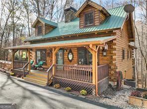 281 Wildwood Ct, Dawsonville, GA 30534 - log home featuring a porch, log exterior, a chimney, and metal roof