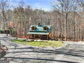 281 Wildwood Ct, Dawsonville, GA 30534 - view of front of house featuring a forest view and a chimney