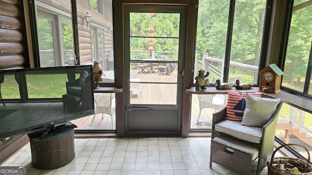396 Greenleaf Dr, Lavonia, GA 30553 - sunroom / solarium featuring rustic walls and tile patterned flooring