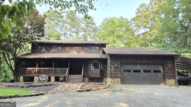 396 Greenleaf Dr, Lavonia, GA 30553 - view of front of house with stone siding, a garage, a porch, gravel driveway, and a shingled roof